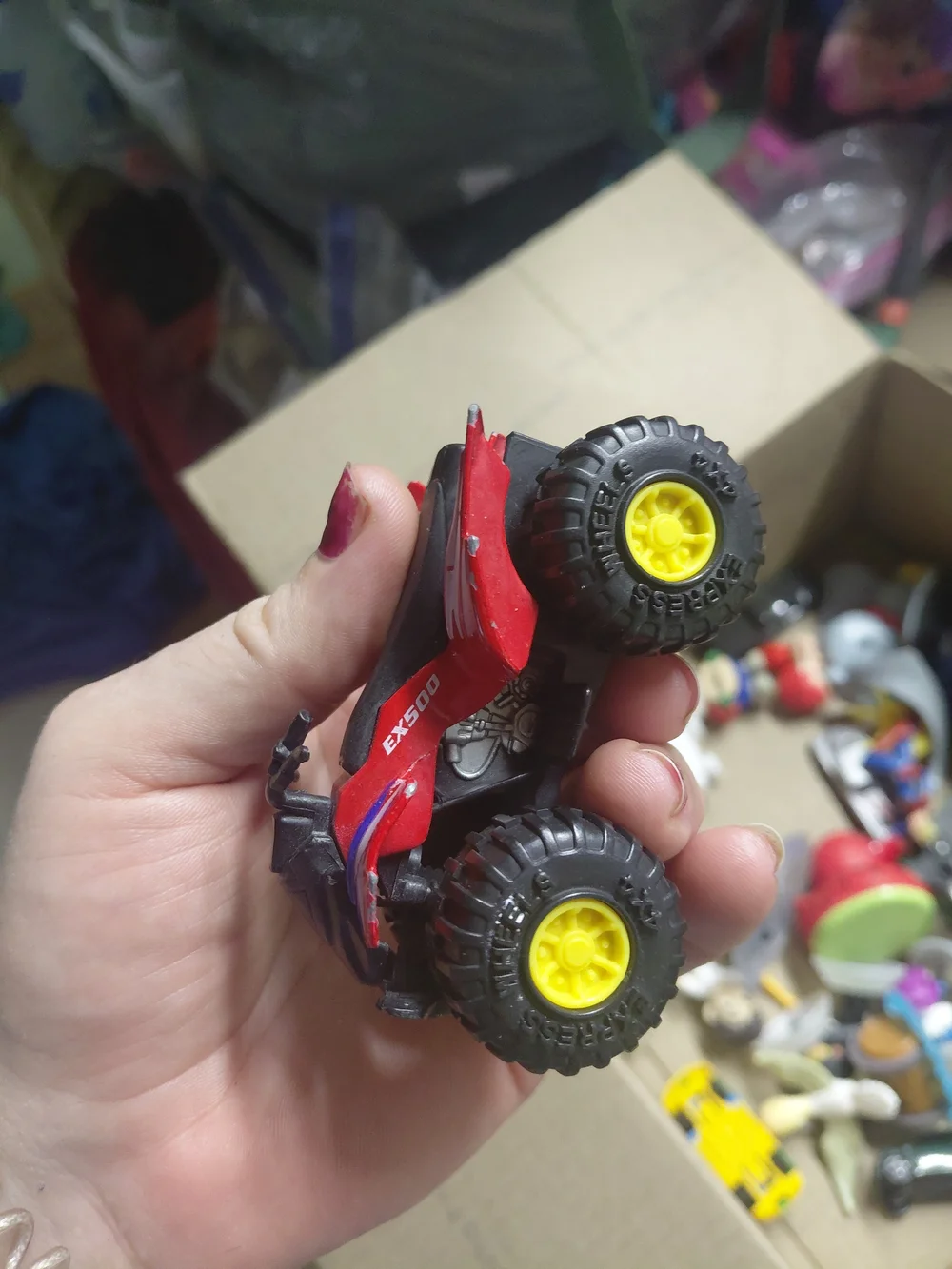 a Greenbrier International EX500 3-inch die-cast red quad ATV toy,